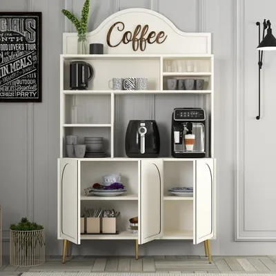 A cream-colored cabinet with gold accents, designed as a coffee bar, is shown in a room setting. It features shelves displaying various kitchen items like mugs, a coffee maker, and an air fryer.