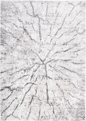 A close-up view of a rug with a distressed abstract pattern.