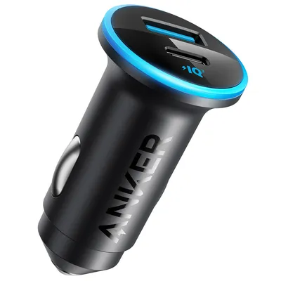 A black Anker car charger with two USB ports and a blue LED light ring.