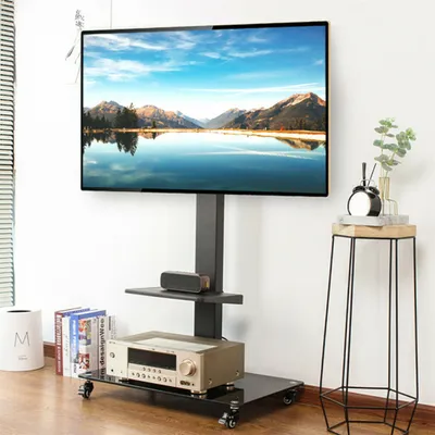 A TV stand with a TV and audio equipment in a room.