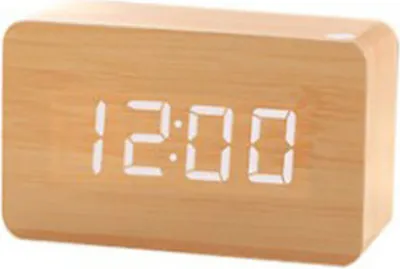 A digital alarm clock with a wood-look finish.