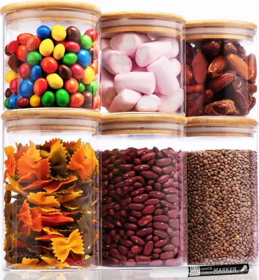A collection of six glass storage jars filled with various food items, arranged in two rows of three.