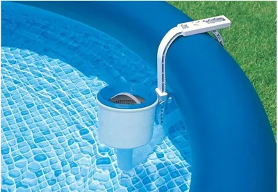 A skimmer is attached to the side of an inflatable pool.