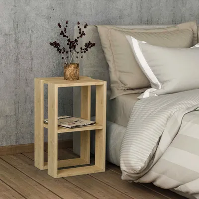 A bedside table next to a bed in a bedroom.