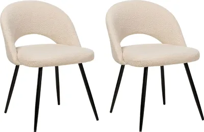 Two cream-colored bouclé chairs with black metal legs are displayed on a white background.