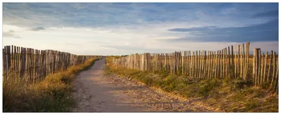 Produktbild von Wallario Wandbild aus Acryl, 200 x 80 cm, freischwebende Optik - Sandweg an einem Strand in Frankreich, Bretagne