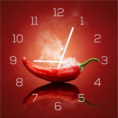 A clock face designed with a chili pepper as the centerpiece, with steam rising from it. The clock numbers are visible around the chili.