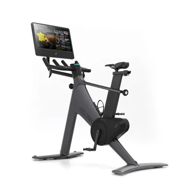 A smart exercise bike with a large touchscreen display, shown against a white background.