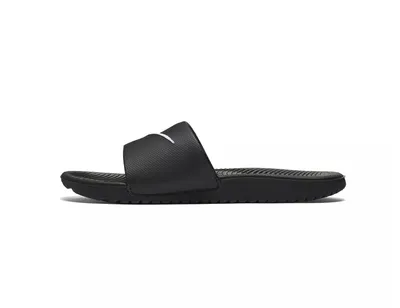 A black Nike Kawa slide sandal is shown from the side against a white background.