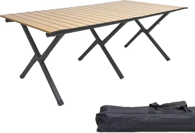 A foldable camping table with a wood-look top and black metal legs, shown with a black carrying bag.
