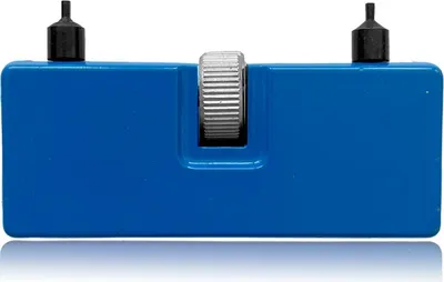 A blue watch case opener tool with a silver adjustment wheel and black prongs is shown against a white background.