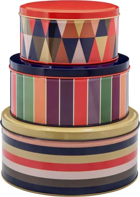 A stack of three round decorative tins with colorful geometric and striped patterns.