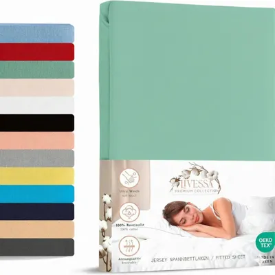 A product image showing a mint green fitted sheet on packaging, with a woman sleeping on a bed in the background. A stack of different colored sheets is shown on the left.