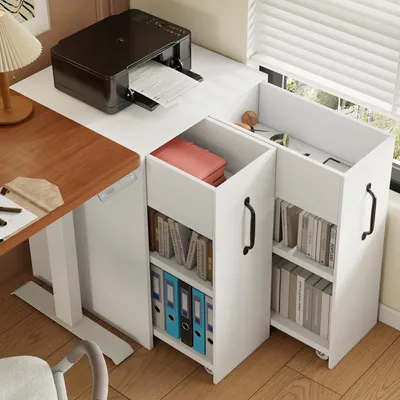 A white mobile filing cabinet with drawers and shelves, placed next to a wooden desk with a printer on top.