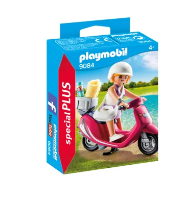 A Playmobil "Strand-Girl mit Roller" (Beach Girl with Scooter) playset packaging, showing the toy figure on a scooter with accessories against a backdrop of a beach and water.