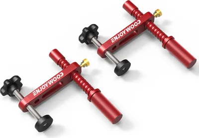 Two red woodworking clamps are displayed on a white background.