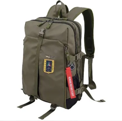 A green backpack with an emblem and a red tag.
