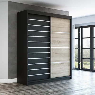 A modern sliding door wardrobe in a room with a concrete wall and wooden floor.