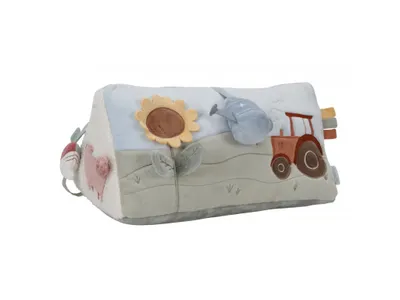 A soft activity triangle toy with farm-themed illustrations.