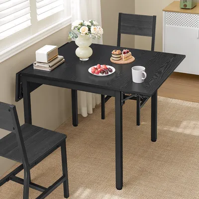 A dining table set up in a room with food and flowers.