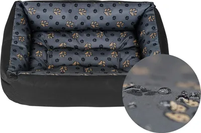 A dog bed with a paw print pattern on a white background.