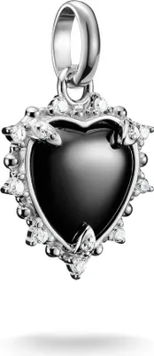 A close-up studio shot of a heart-shaped pendant with black enamel and clear stones, attached to a silver bail.