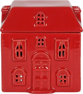 A red ceramic house-shaped oil burner.