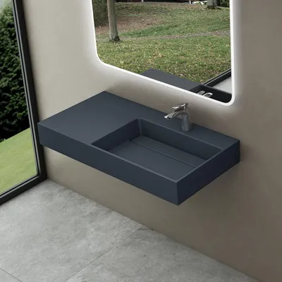A modern bathroom sink with a faucet, set against a wall with a large window showing an outdoor scene.