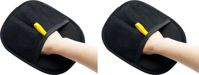 A hand wearing a black pet grooming glove with a yellow loop.