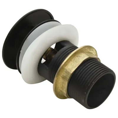 A close-up view of a sink drain assembly with black and white components and a brass nut.