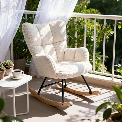 A cozy rocking chair on a balcony with plants and sheer curtains.