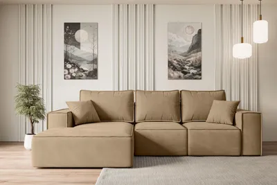 A modern living room with a beige sectional sofa, two pieces of abstract art on the wall, and pendant lights hanging from the ceiling.