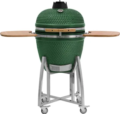 A green ceramic kamado grill on a silver stand with wooden side shelves, presented against a white background.