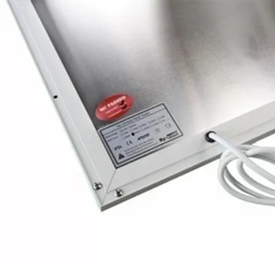 Close-up view of the back of a panel heater, showing a label and a power cord.