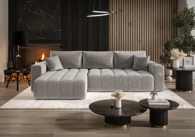 A modern living room with a fireplace, wooden wall paneling, and a large sectional sofa.