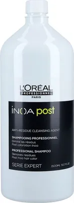A white bottle of L'Oréal INOA Post-Shampoo is shown against a white background.