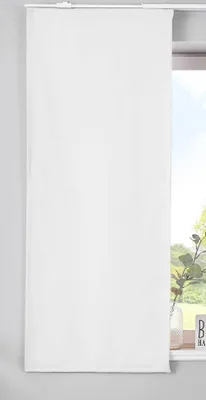 A white panel curtain hanging in front of a window.