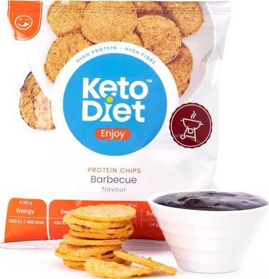A bag of barbecue flavored protein chips with a bowl of dip and some chips in the foreground.