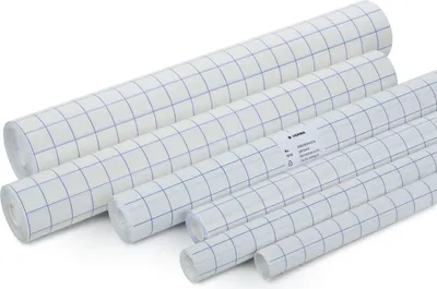 Several rolls of transparent protective film with a grid pattern are arranged diagonally on a white background.