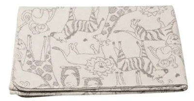 A folded baby blanket with a safari animal print.