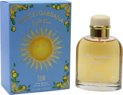 Hellblaue Duftbox mit goldener Sonne und Zitronenmotiv, daneben runder Glasflakon mit honigfarbenem Inhalt und cremeweißer Kappe.