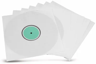 A stack of white LP record sleeves, with one sleeve showing a white record with a green label.
