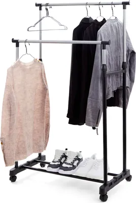 A double-tiered garment rack holding clothes and shoes.