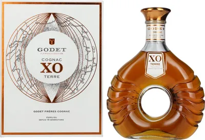 A bottle of Godet Cognac XO TERRE and its gift box are displayed side-by-side against a white background.