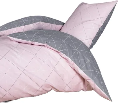 A close-up view of a bedding set, showing a pillow and a duvet cover.