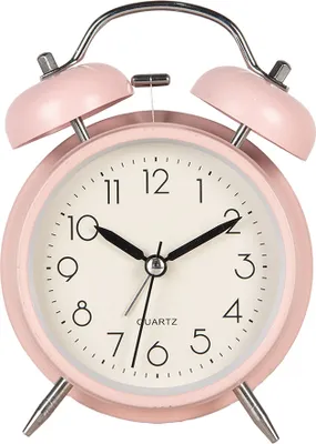 A pink analog alarm clock with silver bells on top, set against a white background.