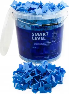 A bucket full of blue tile leveling clips, with a pile of clips in front of it.