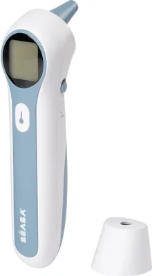 A close-up studio shot of a white and light blue Beaba ear thermometer with its white base stand.