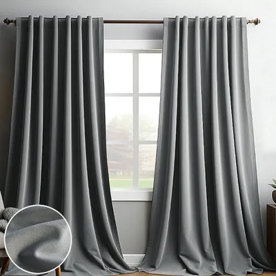 Two gray curtains are hanging on a window rod, covering a window. A close-up of the fabric texture is shown in the bottom left corner.