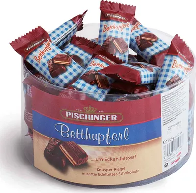A clear plastic container filled with individually wrapped chocolates.
